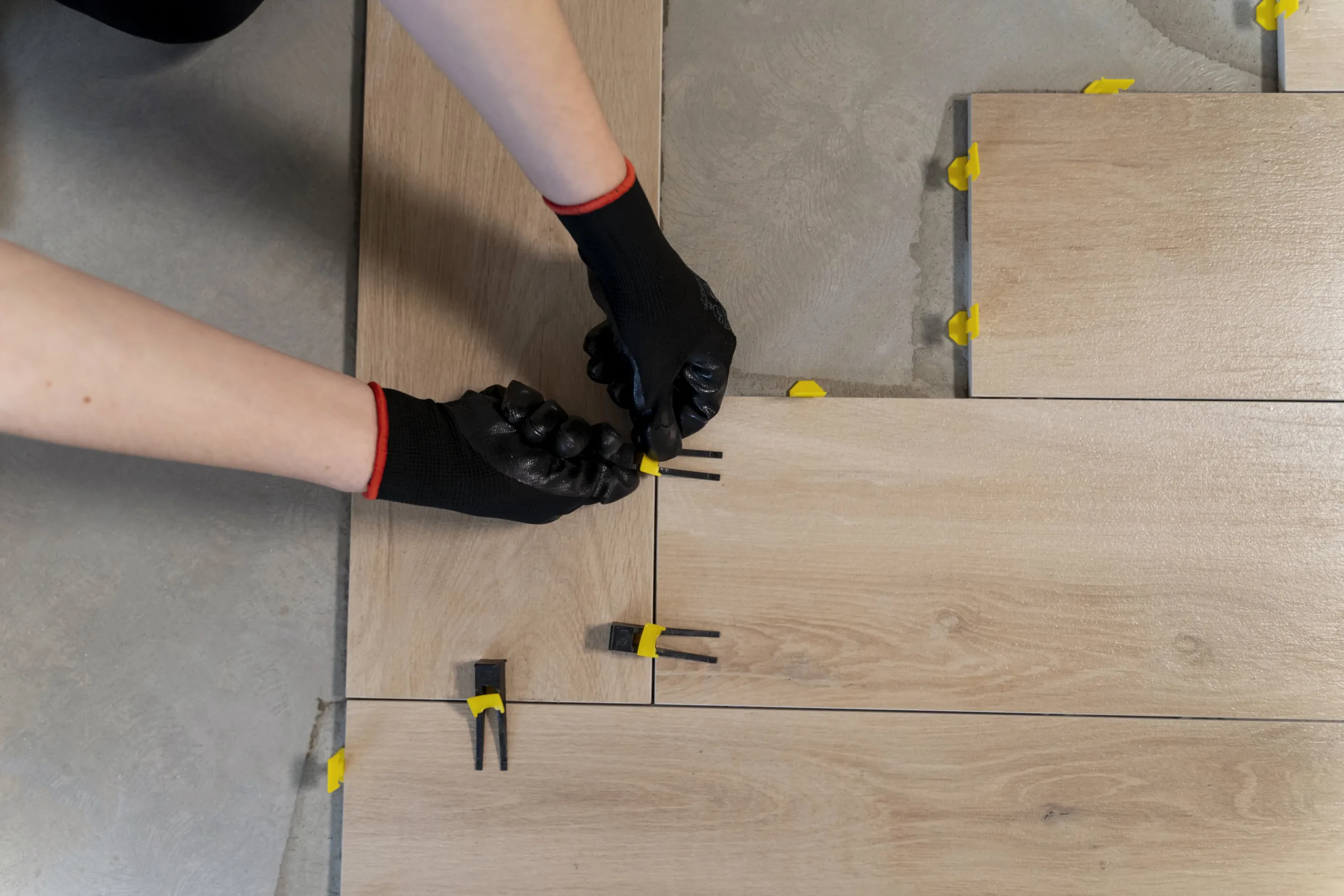 flat-lay-worker-tiling-floor-min